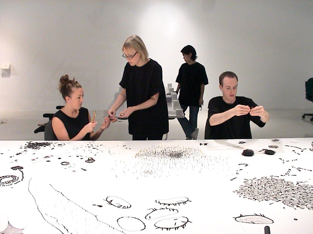 photo of Anne Wilson installing Topologies with assistants
